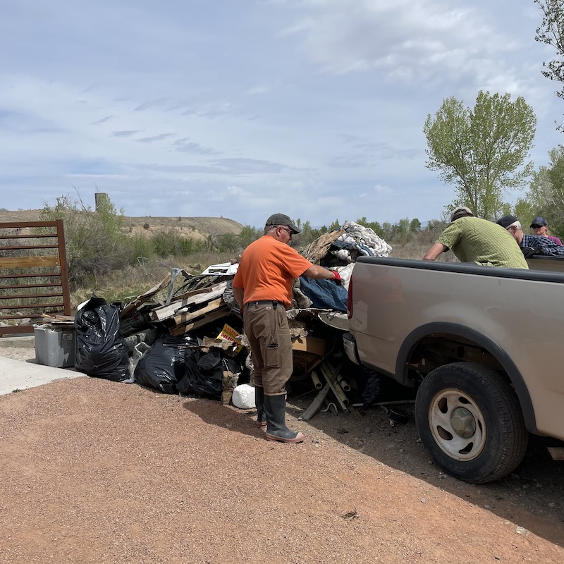 Friends of the River Uncompahgre, FORU Montrose, loading trash in trucks after a river cleanup. 